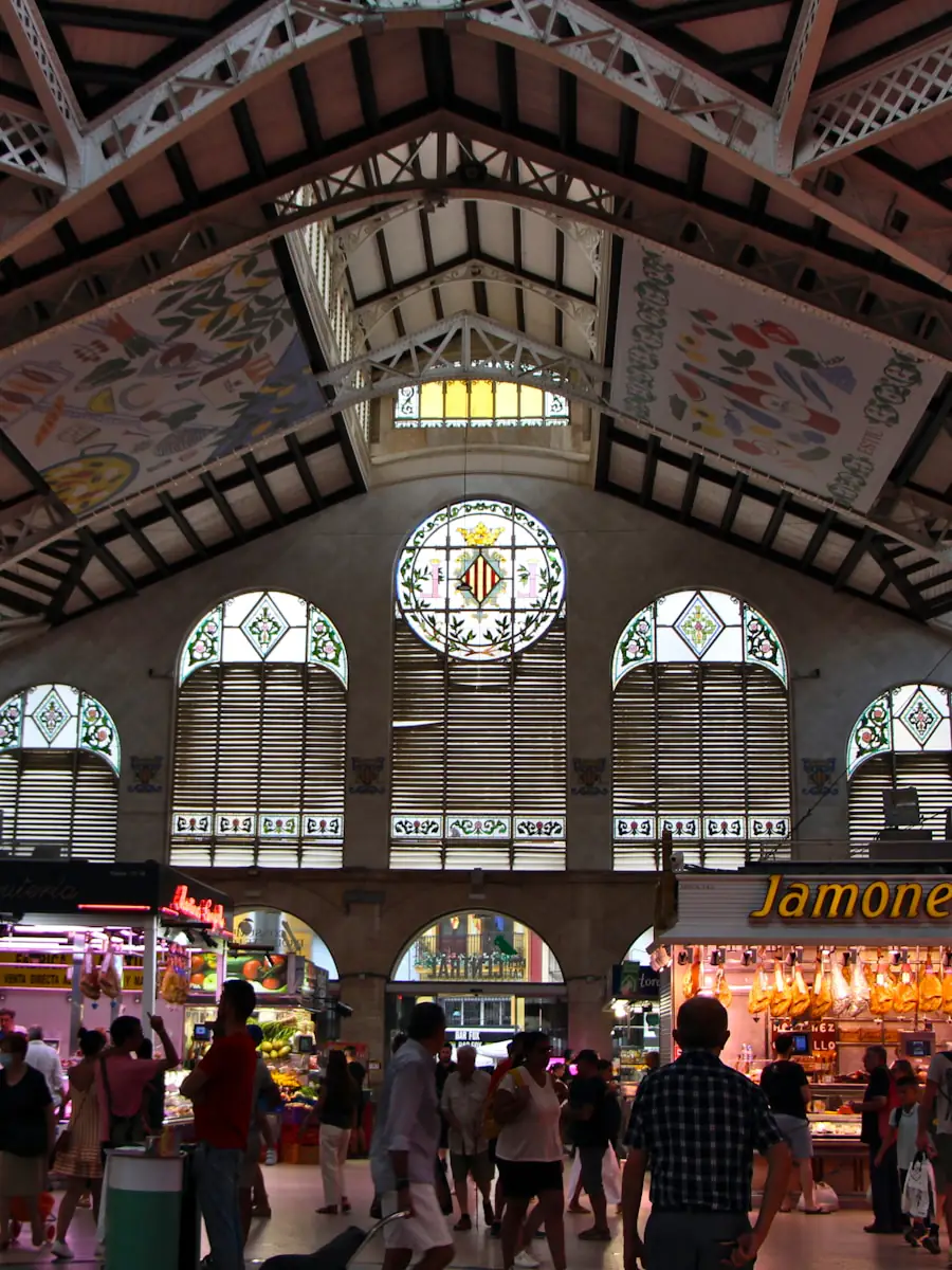 El interior del Mercat Central de València, con sus vidrieras y la gente entre los puestos